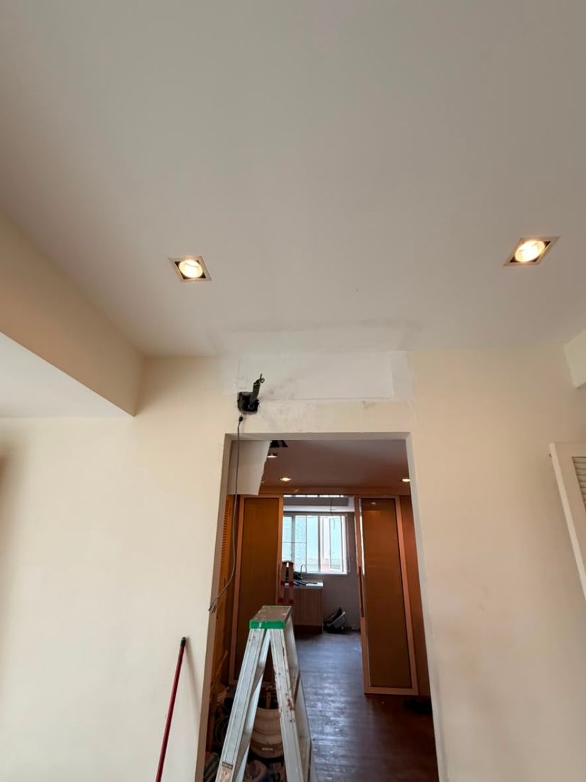 Bare wall above the dry kitchen doorway with the pipe outlet ready