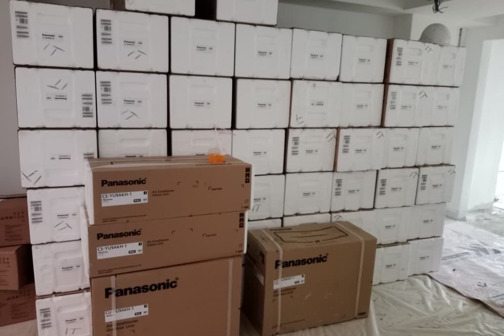 Dozens of boxed Panasonic units staged on site before installation