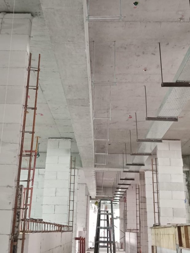 Bare concrete slab with cable trays and hangers installed